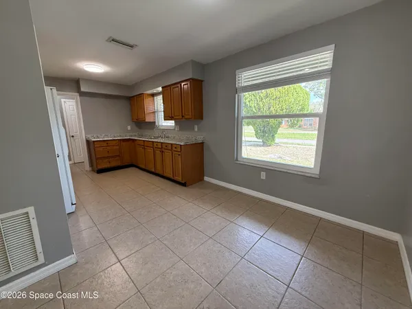 a room with washing machine and windows