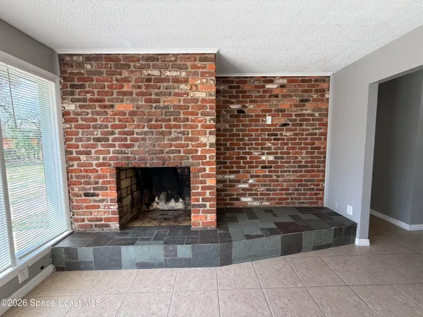 a view of an empty room with a fireplace