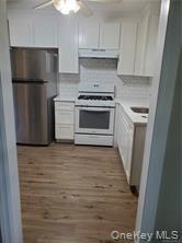 349 South Middletown Road Nanuet, NY 10954 - Photo 2 of 9 a kitchen with a refrigerator stove and white cabinets