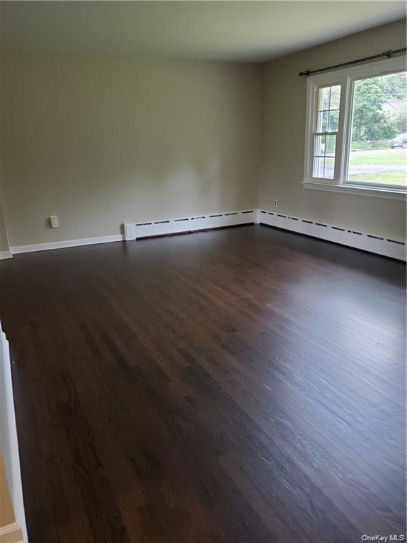 349 South Middletown Road Nanuet, NY 10954 - Photo 4 of 9 an empty room with wooden floor and windows