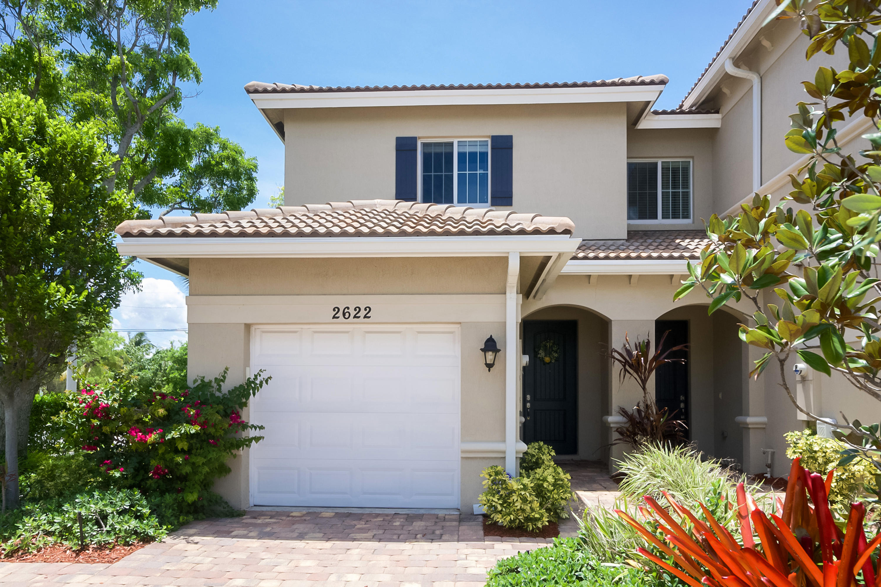 2622 Webb Avenue Delray Beach, FL 33444 - Photo 1 of 16 a front view of a house with a garden
