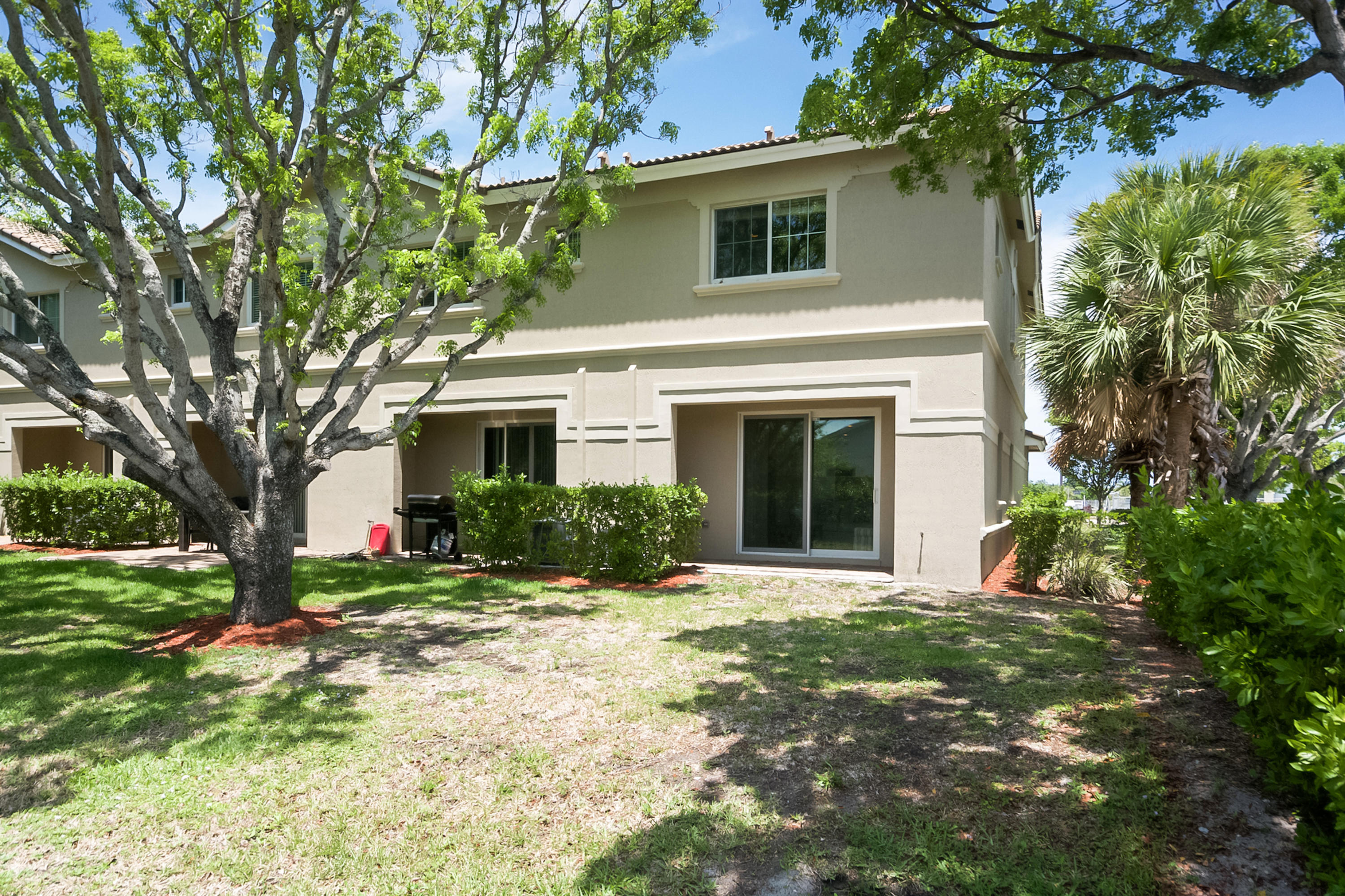 2622 Webb Avenue Delray Beach, FL 33444 - Photo 14 of 16 a front view of a house with a yard and potted plants