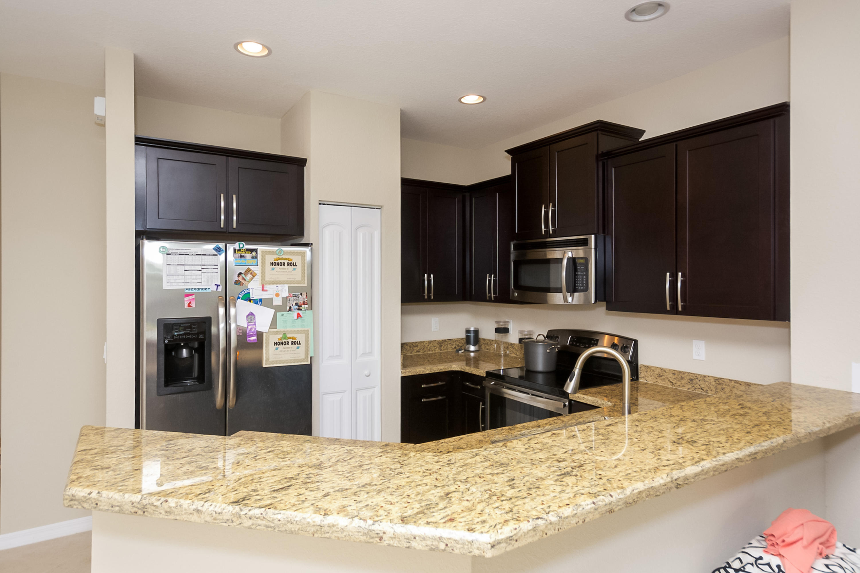 2622 Webb Avenue Delray Beach, FL 33444 - Photo 6 of 16 a kitchen with granite countertop a refrigerator and a sink