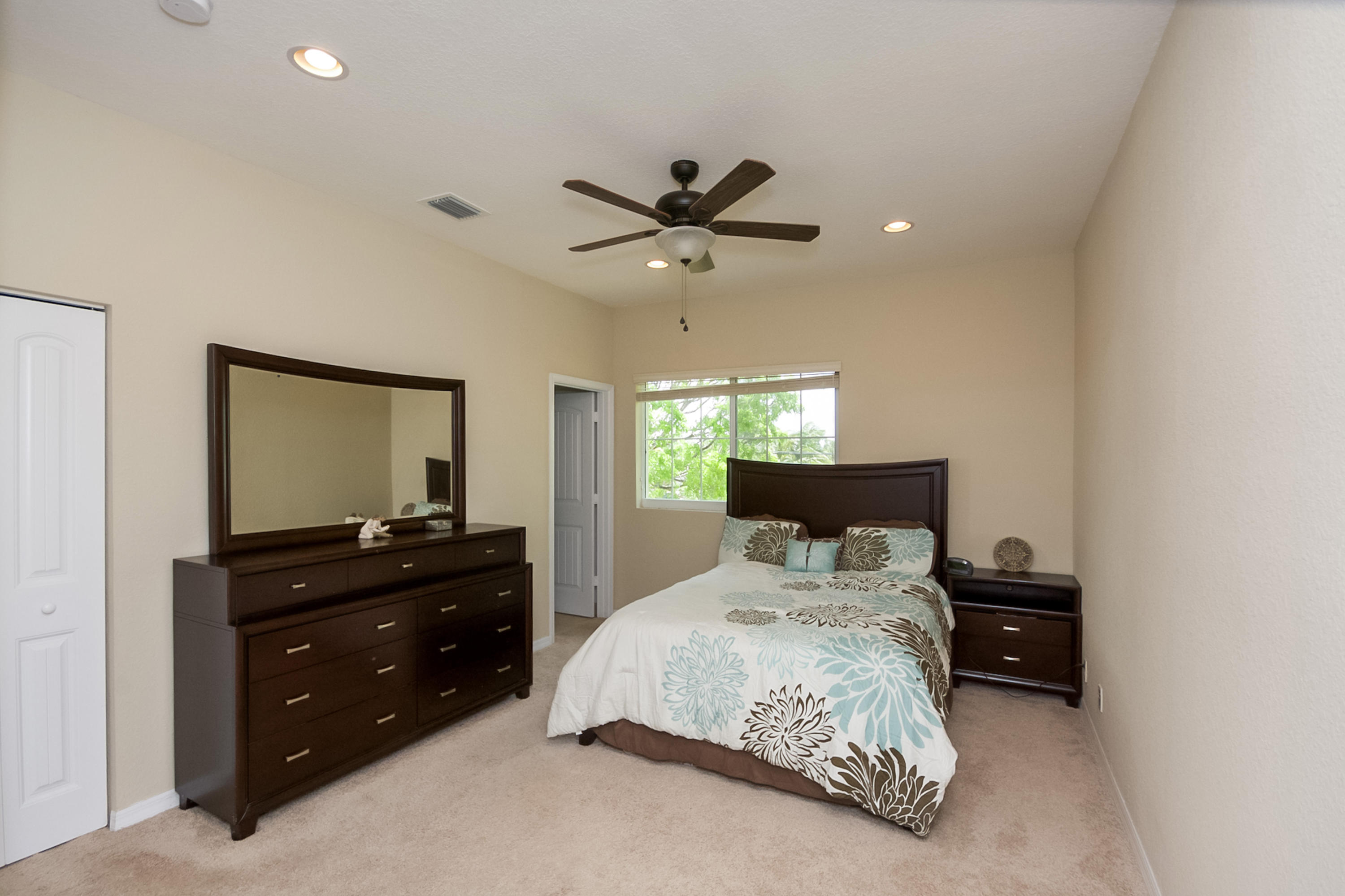 2622 Webb Avenue Delray Beach, FL 33444 - Photo 7 of 16 a bedroom with a bed and a chandelier