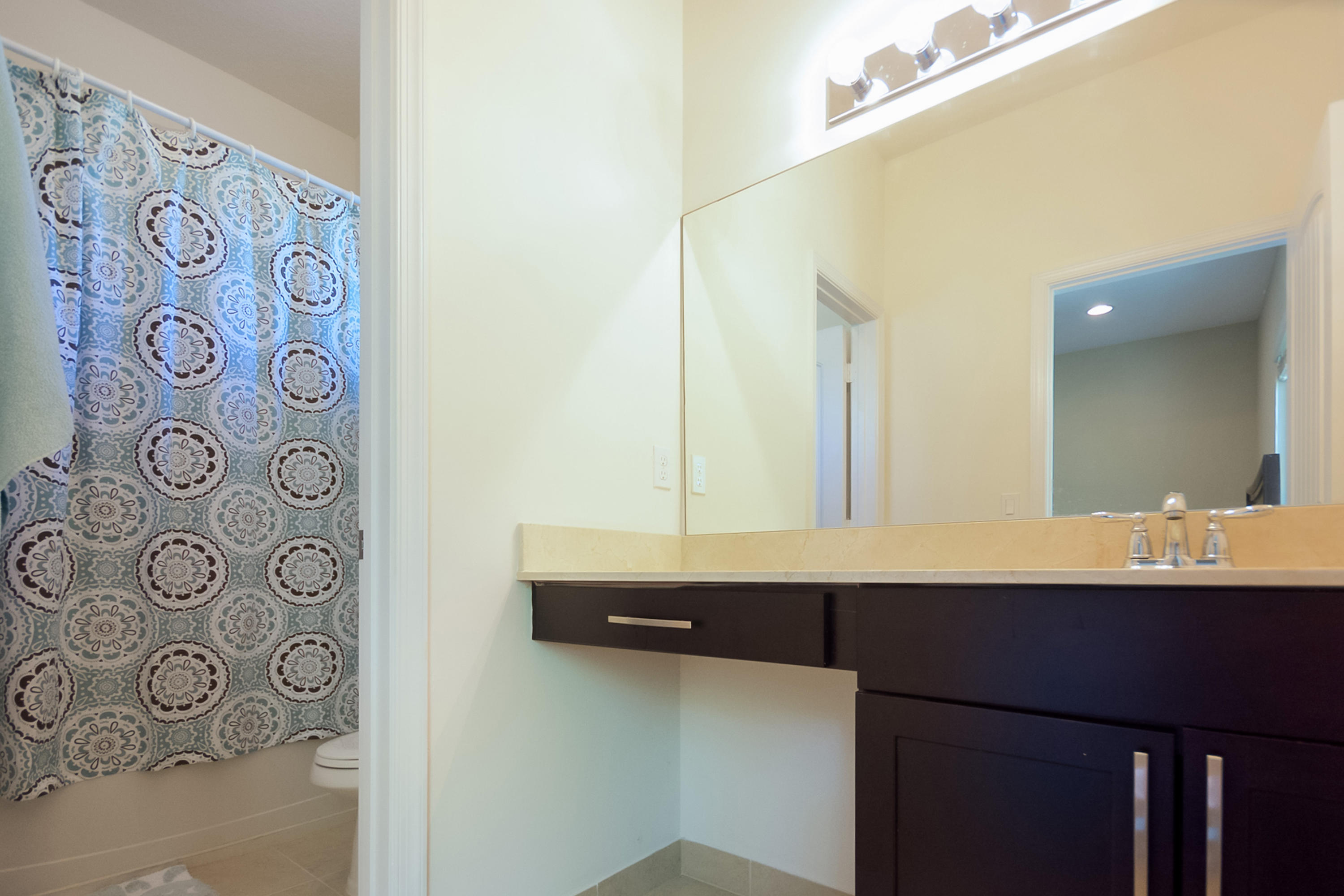 2622 Webb Avenue Delray Beach, FL 33444 - Photo 8 of 16 a bathroom with a sink and a mirror