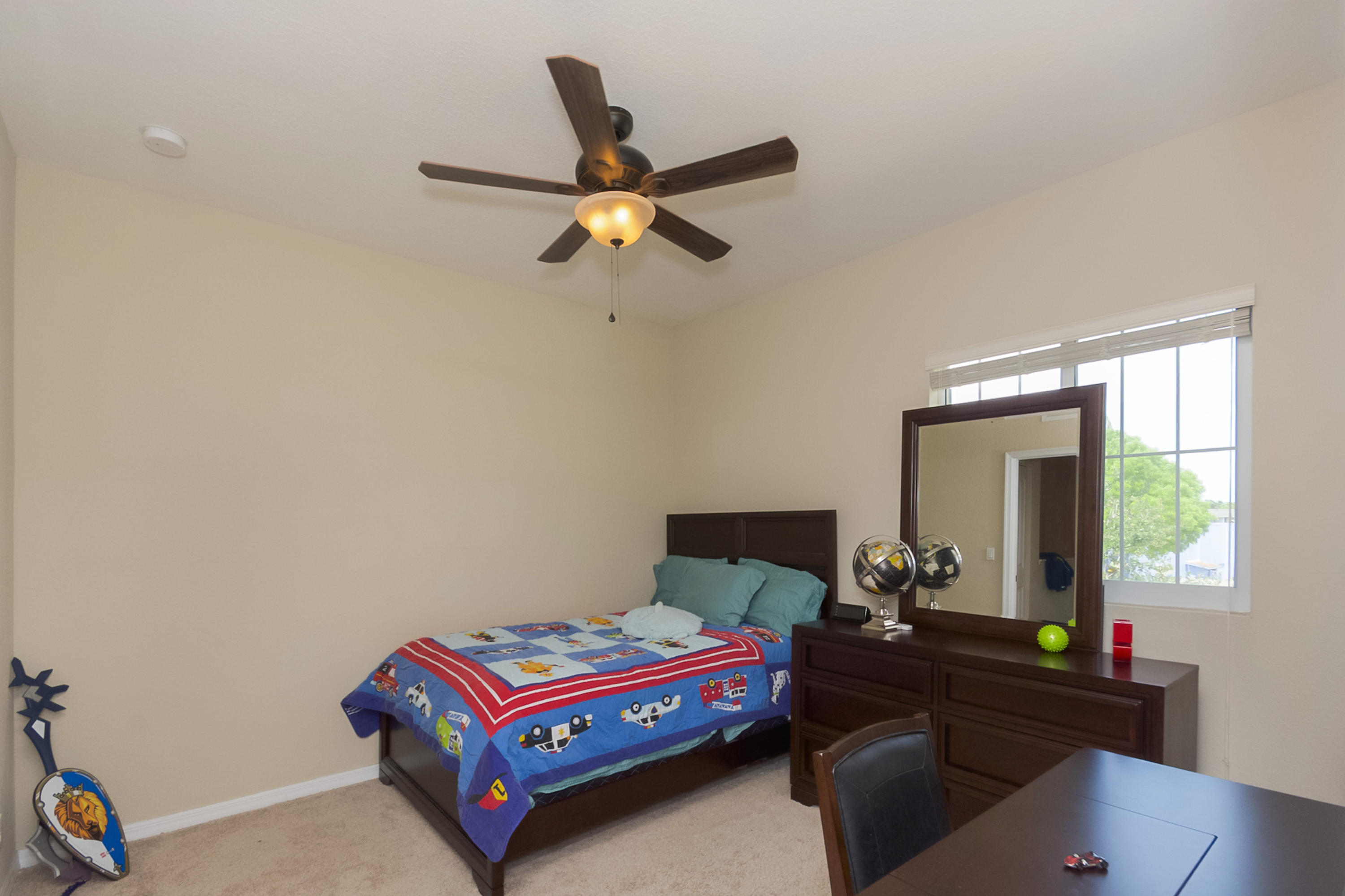 2622 Webb Avenue Delray Beach, FL 33444 - Photo 10 of 16 a room with a bed and a chandelier