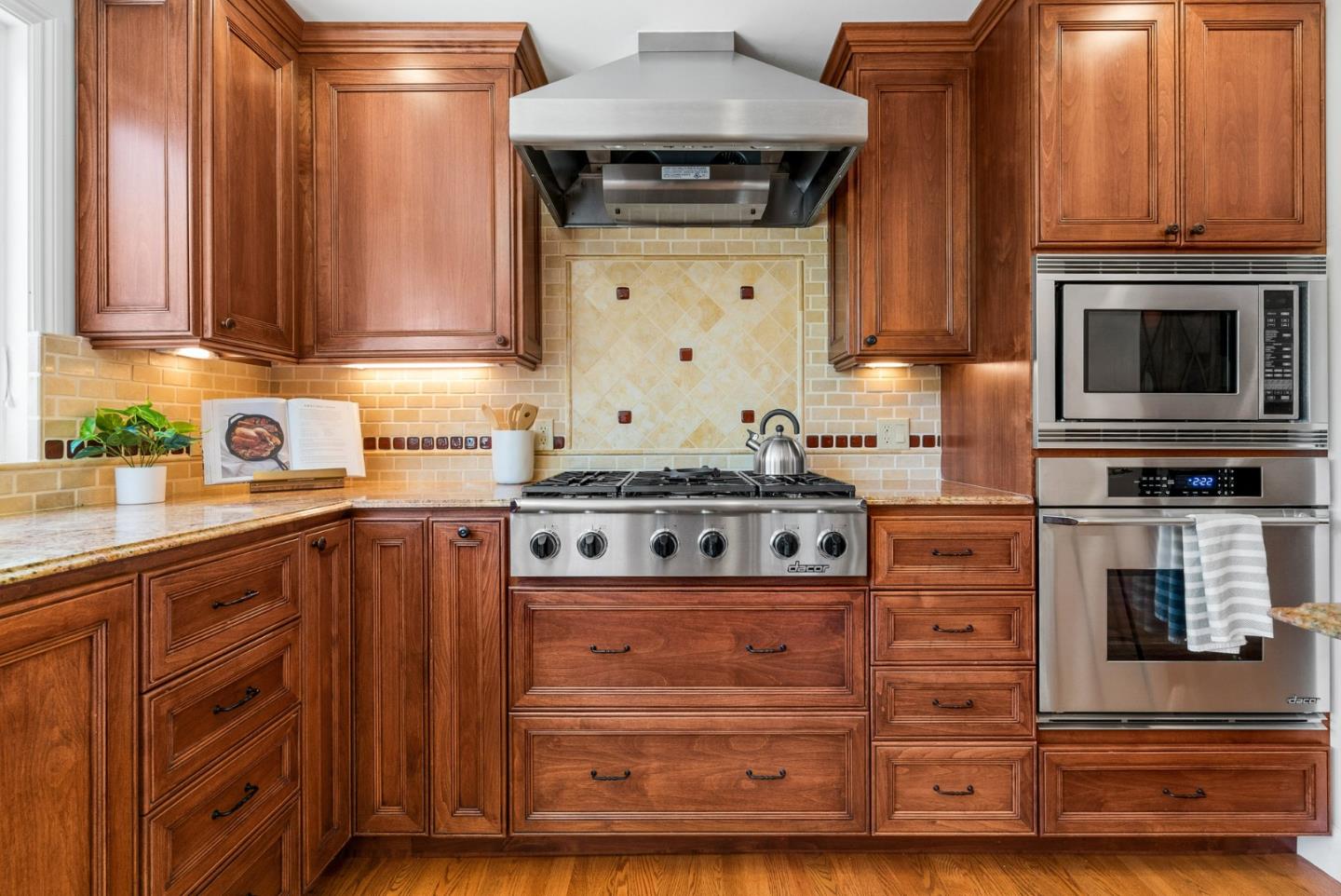 144 Victoria Lane Aptos, CA 95003 - Photo 12 of 36 a kitchen with stainless steel appliances granite countertop a stove and a microwave oven with cabinets