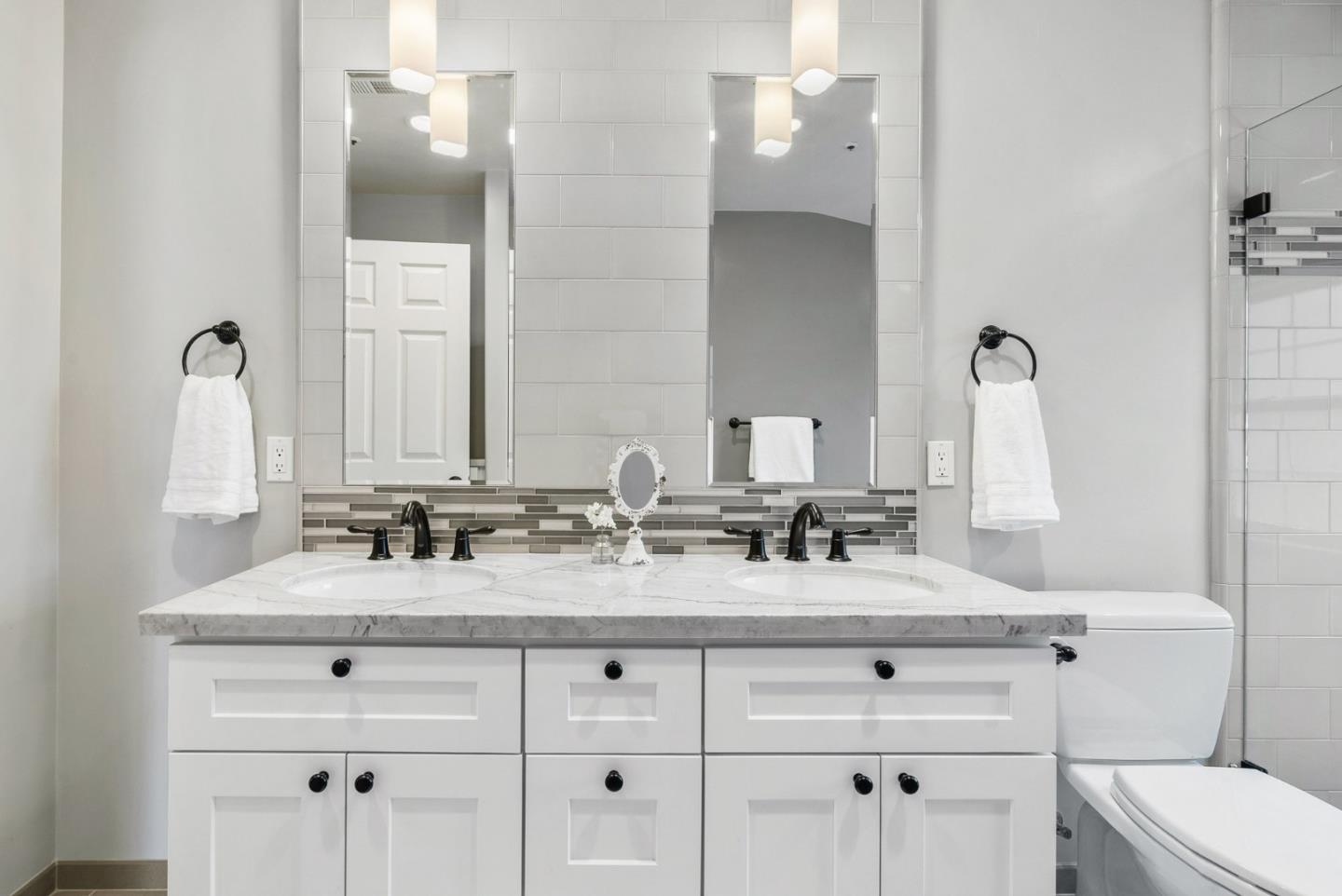 144 Victoria Lane Aptos, CA 95003 - Photo 18 of 36 a bathroom with double vanity sinks a toilet and a mirror
