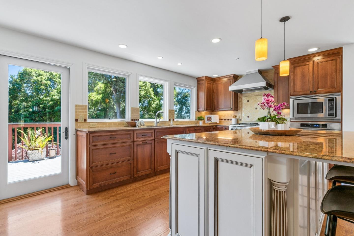 144 Victoria Lane Aptos, CA 95003 - Photo 10 of 36 a kitchen with kitchen island granite countertop a stove and a sink with cabinets