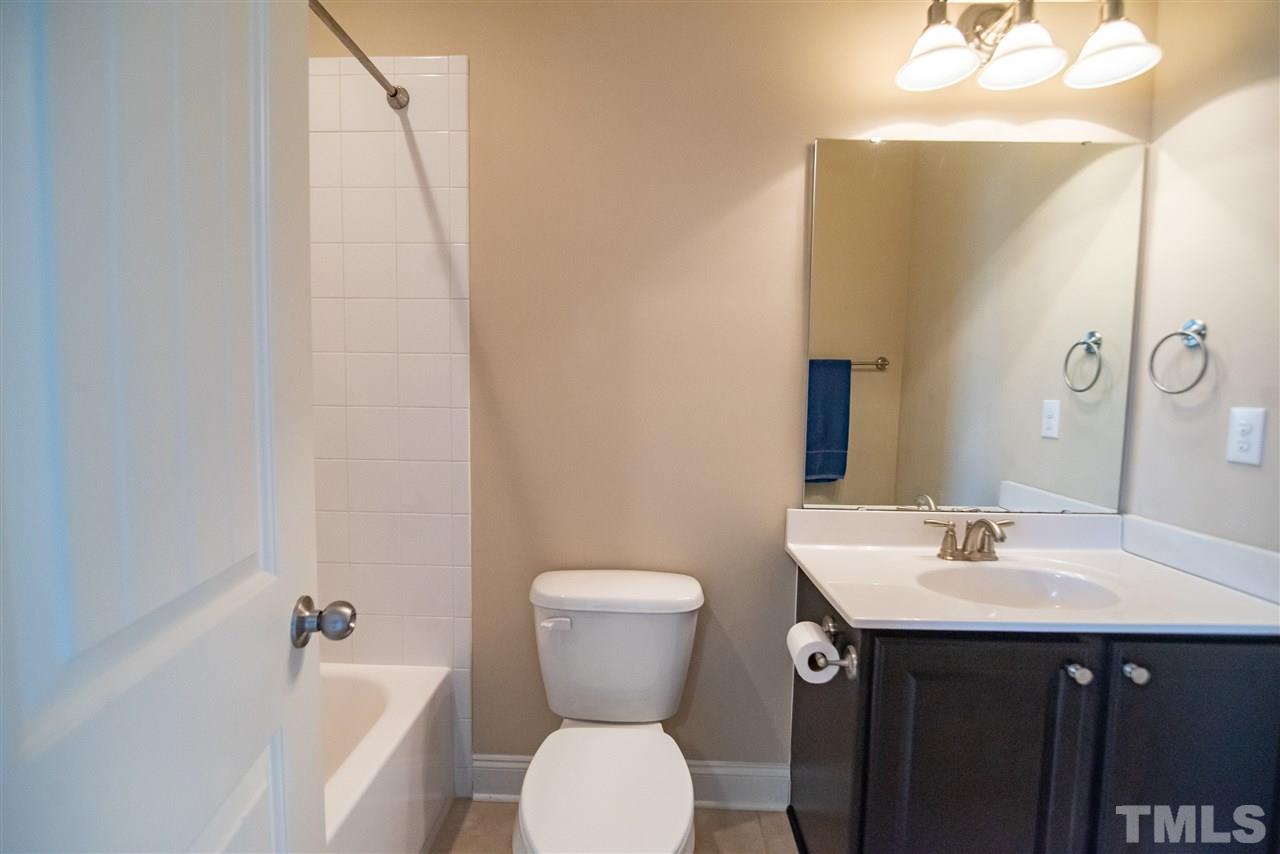2720 Country Charm Road Raleigh, NC 27614 - Photo 17 of 30 Private second floor bathroom with single vanity sink and tub/shower.