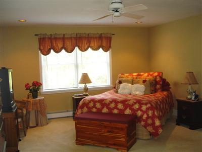 Undisclosed Address Marstons Mills, MA 02648 - Photo 7 of 10 a bedroom with a bed and a window