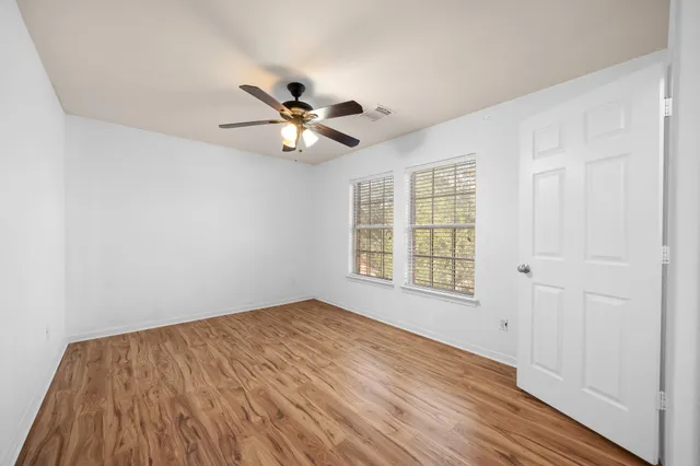 a view of an empty room and wooden floor