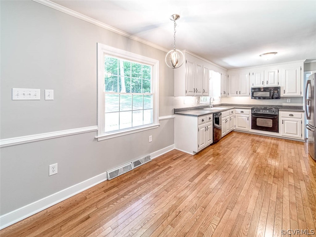 7260 Beach Road Chesterfield, VA 23832 - Photo 10 of 20 a large kitchen with granite countertop a stove a sink dishwasher a refrigerator and wooden floor