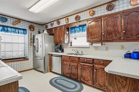a kitchen with stainless steel appliances granite countertop a sink stove and cabinets