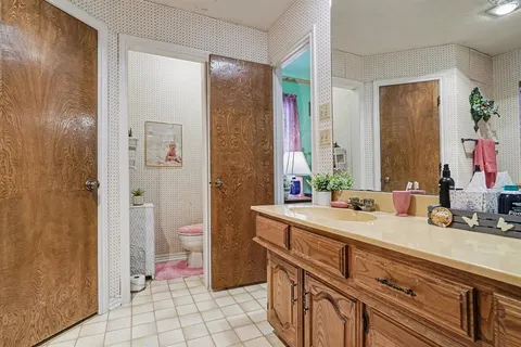 a bedroom with a bed and chair
