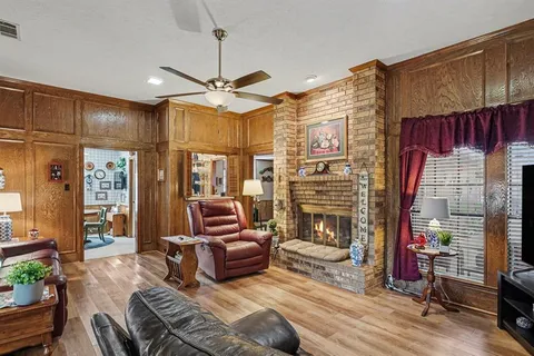 a living room with fireplace furniture and a flat screen tv