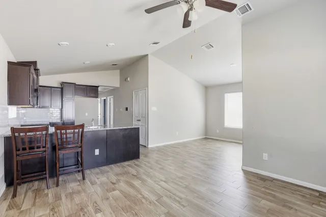 a view of workspace with furniture and wooden floor