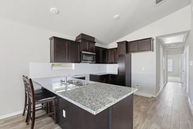 a kitchen with a table and chairs in it