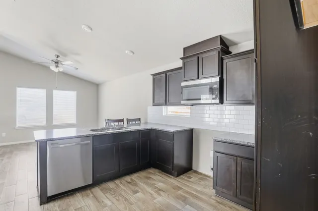 a kitchen with cabinets and window