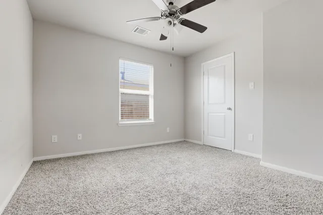 a view of an empty room with a window