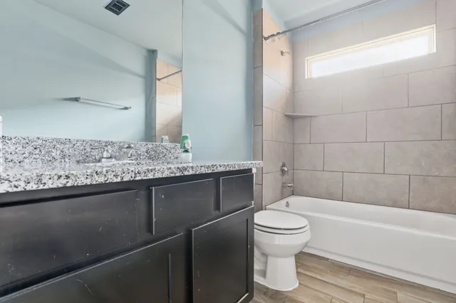 a bathroom with a sink toilet and shower