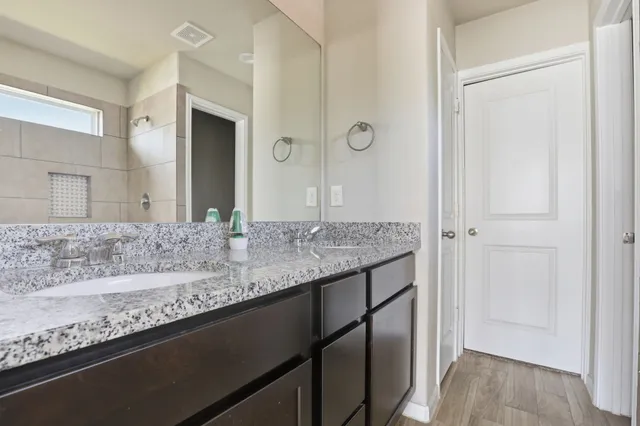 a kitchen with granite countertop a stove a sink and a microwave