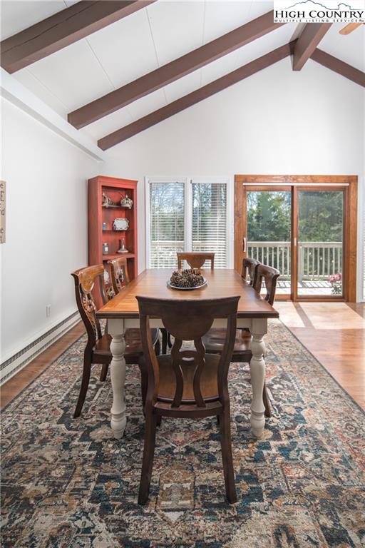 485 Chestnut Drive Boone, NC 28607 - Photo 14 of 48 a dining room with furniture a rug and a floor to ceiling window