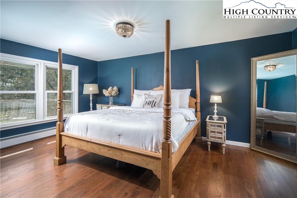 485 Chestnut Drive Boone, NC 28607 - Photo 16 of 48 a bedroom with a bed and a large window