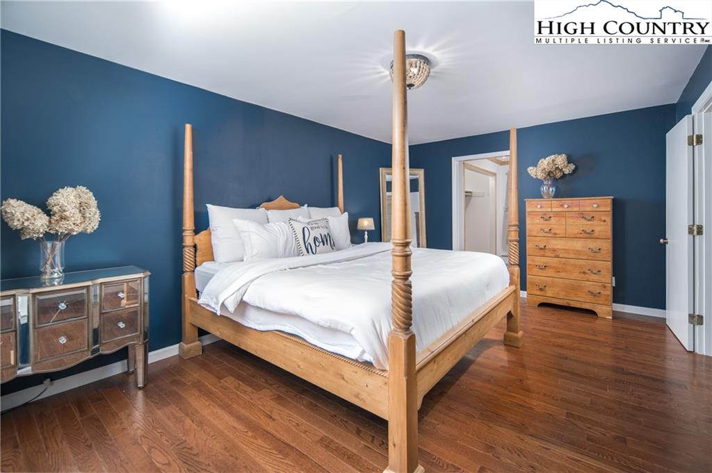 485 Chestnut Drive Boone, NC 28607 - Photo 17 of 48 a bedroom with a bed and a chandelier