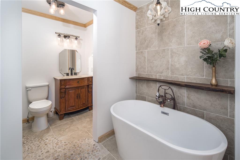 485 Chestnut Drive Boone, NC 28607 - Photo 19 of 48 a bathroom with a sink a toilet and mirror