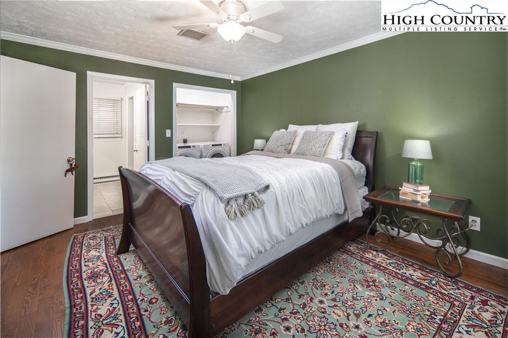 485 Chestnut Drive Boone, NC 28607 - Photo 23 of 48 a bedroom with a bed lamps and wooden floor