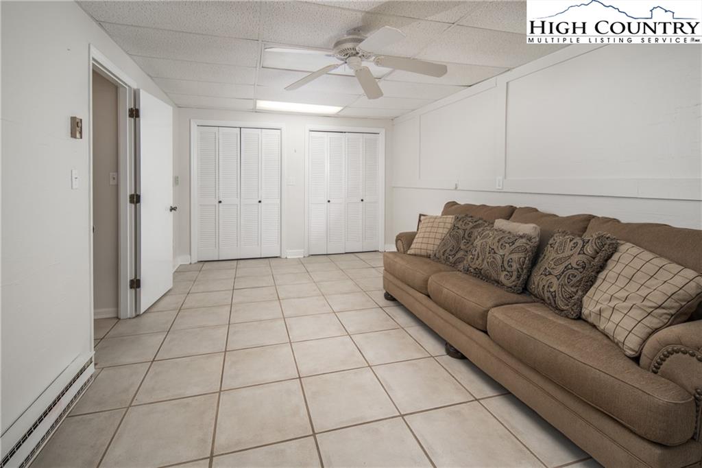 485 Chestnut Drive Boone, NC 28607 - Photo 27 of 48 a living room with a couch and a walk in closet with wooden floor