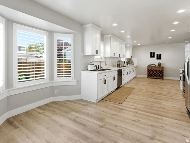 1405 Vintry Lane Murray, UT 84121 - Photo 14 of 44 Spacious kitchen and dining area featuring light wood-finish flooring