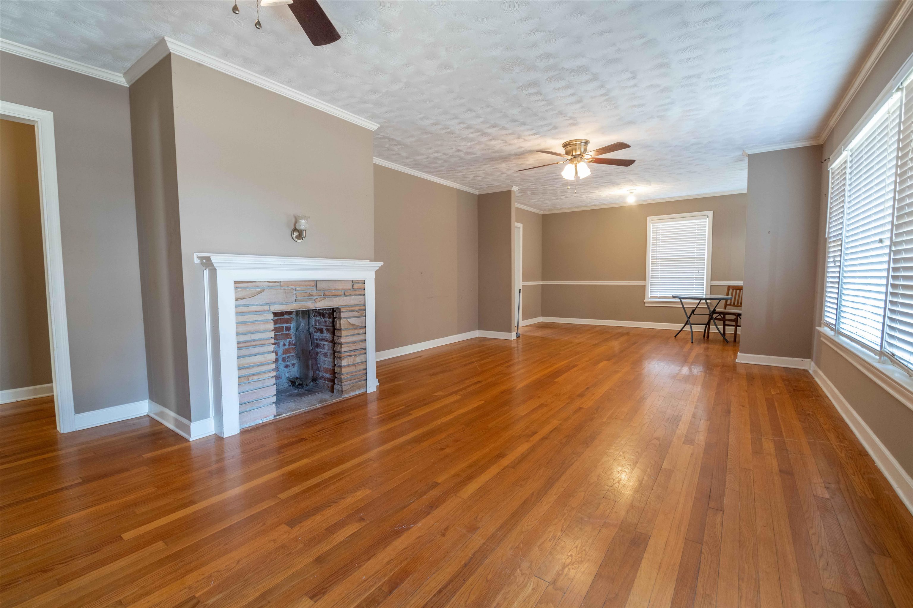 1227 Whitten Road Memphis, TN 38134 - Photo 6 of 15 a view of empty room with wooden floor and fan