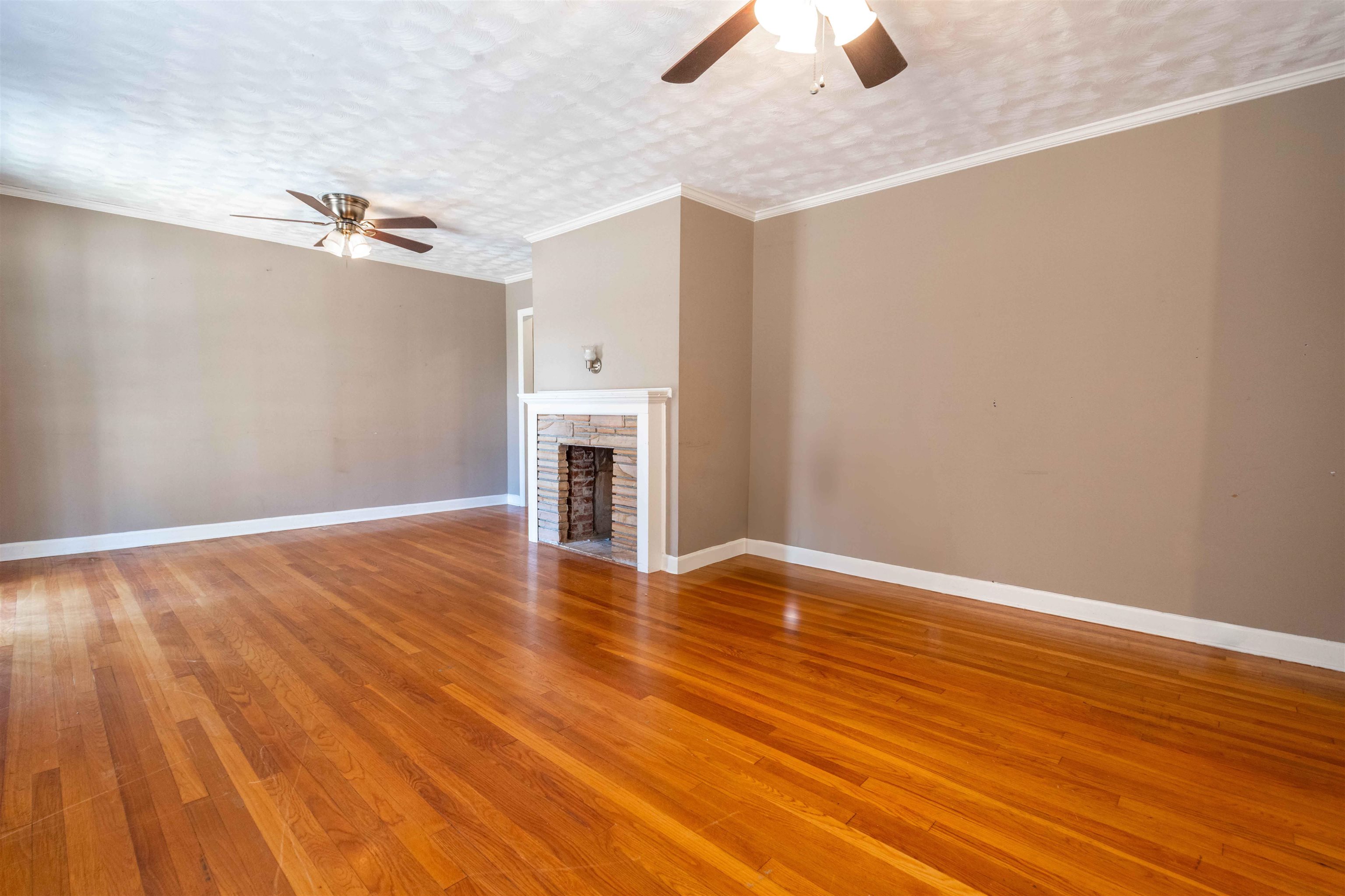 1227 Whitten Road Memphis, TN 38134 - Photo 7 of 15 a view of empty room with wooden floor and fan