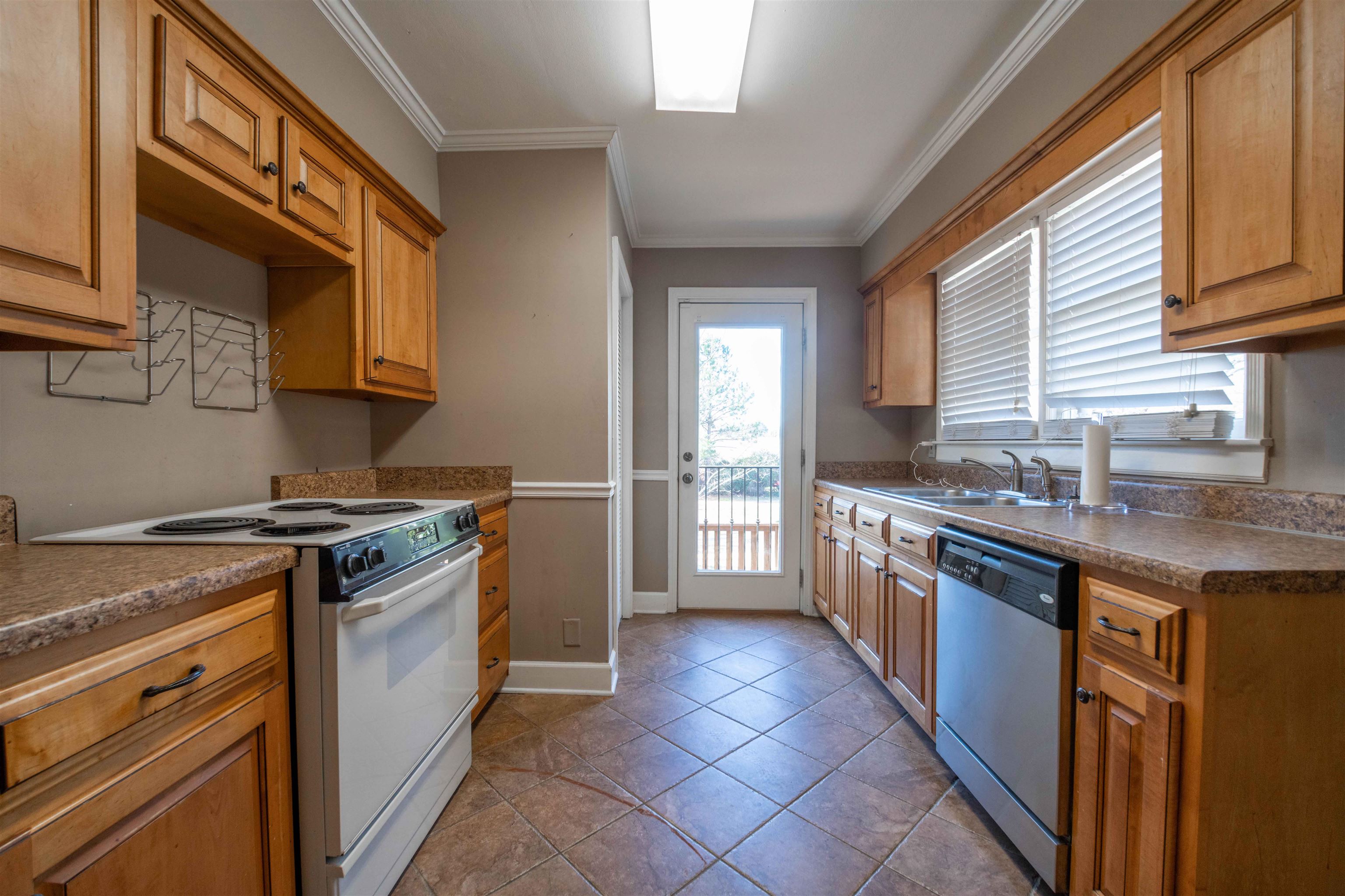 1227 Whitten Road Memphis, TN 38134 - Photo 9 of 15 a kitchen with stainless steel appliances granite countertop a stove a sink and a microwave