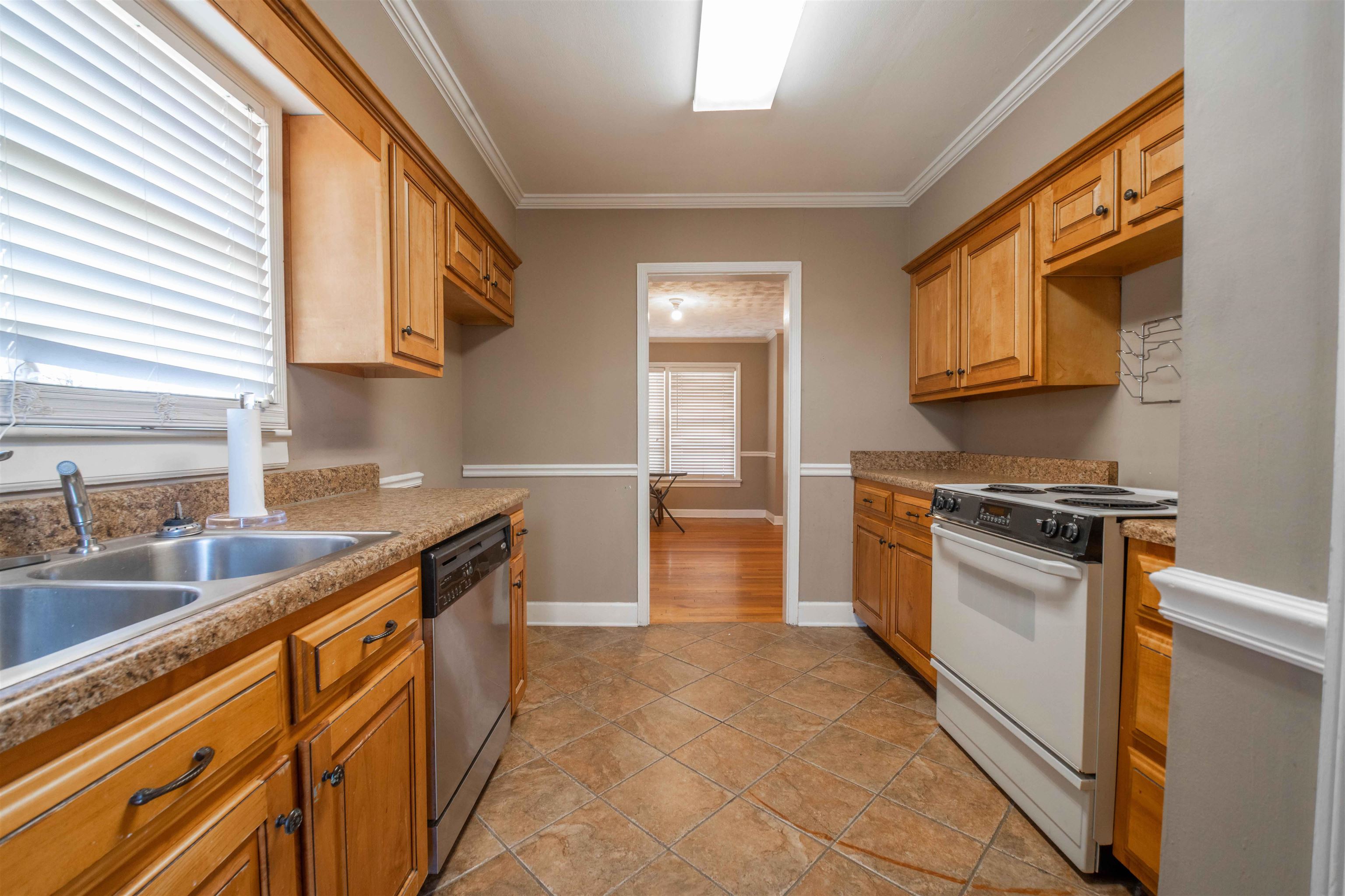 1227 Whitten Road Memphis, TN 38134 - Photo 10 of 15 a kitchen with stainless steel appliances granite countertop a stove a sink and a microwave