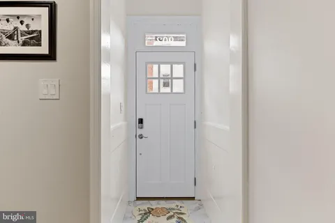a bathroom with a painting on the wall and a window