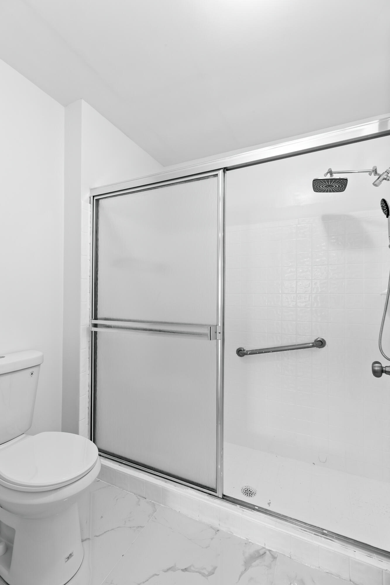 8089 Springtree Road Boca Raton, FL 33496 - Photo 16 of 35 a bathroom with a toilet and a shower