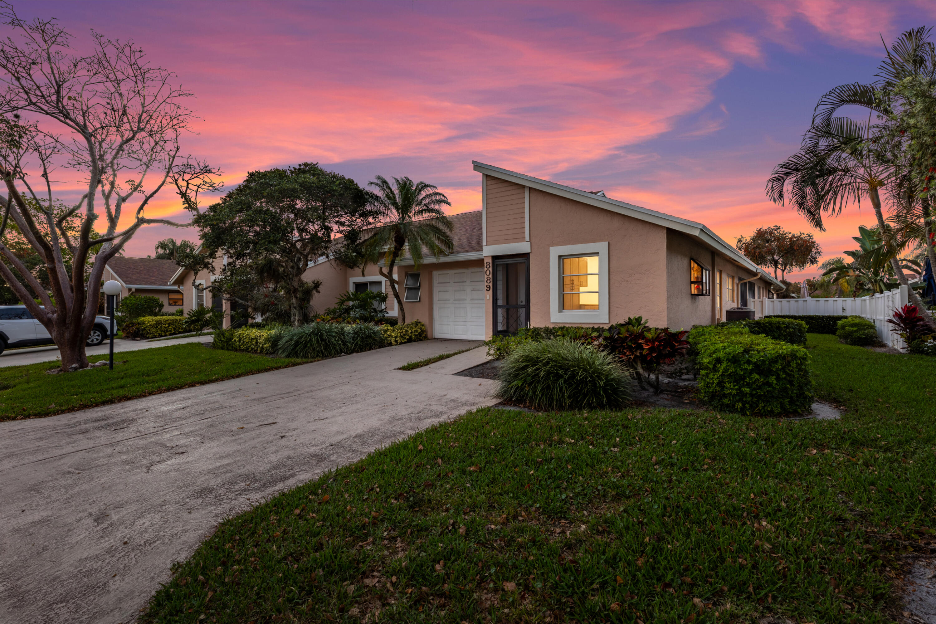 8089 Springtree Road Boca Raton, FL 33496 - Photo 21 of 35 a front view of a house with a yard and garage