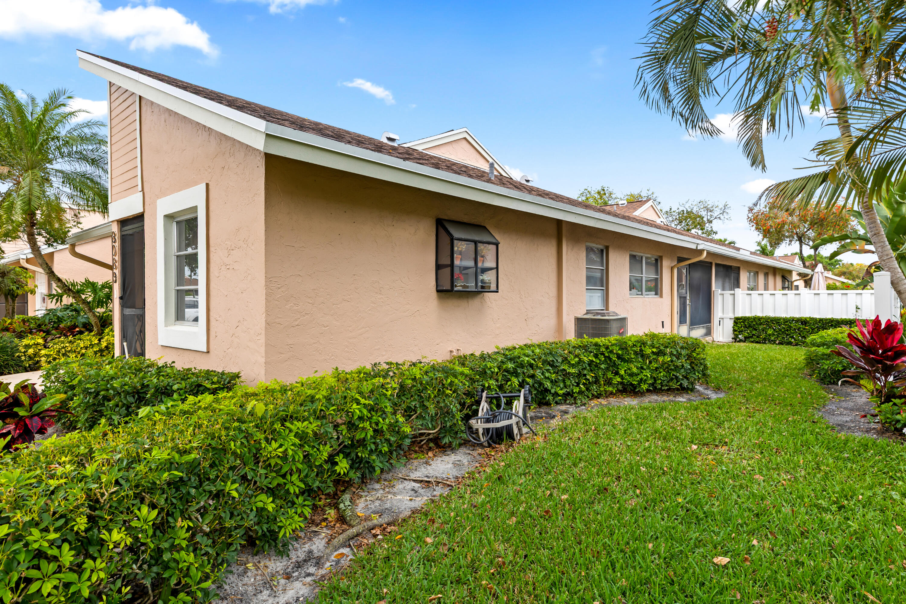 8089 Springtree Road Boca Raton, FL 33496 - Photo 23 of 35 a front view of a house with garden