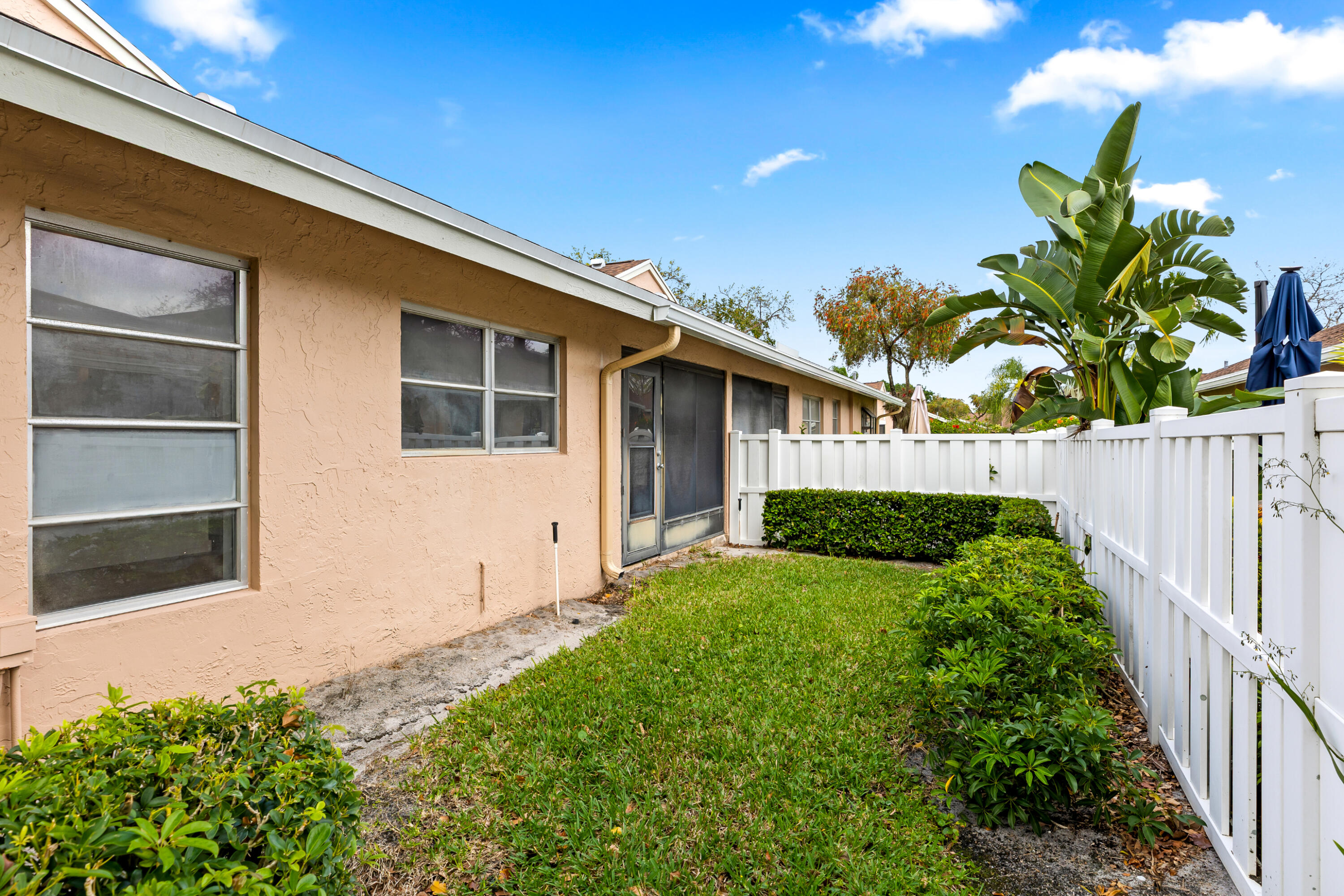 8089 Springtree Road Boca Raton, FL 33496 - Photo 24 of 35 a front view of a house with a yard