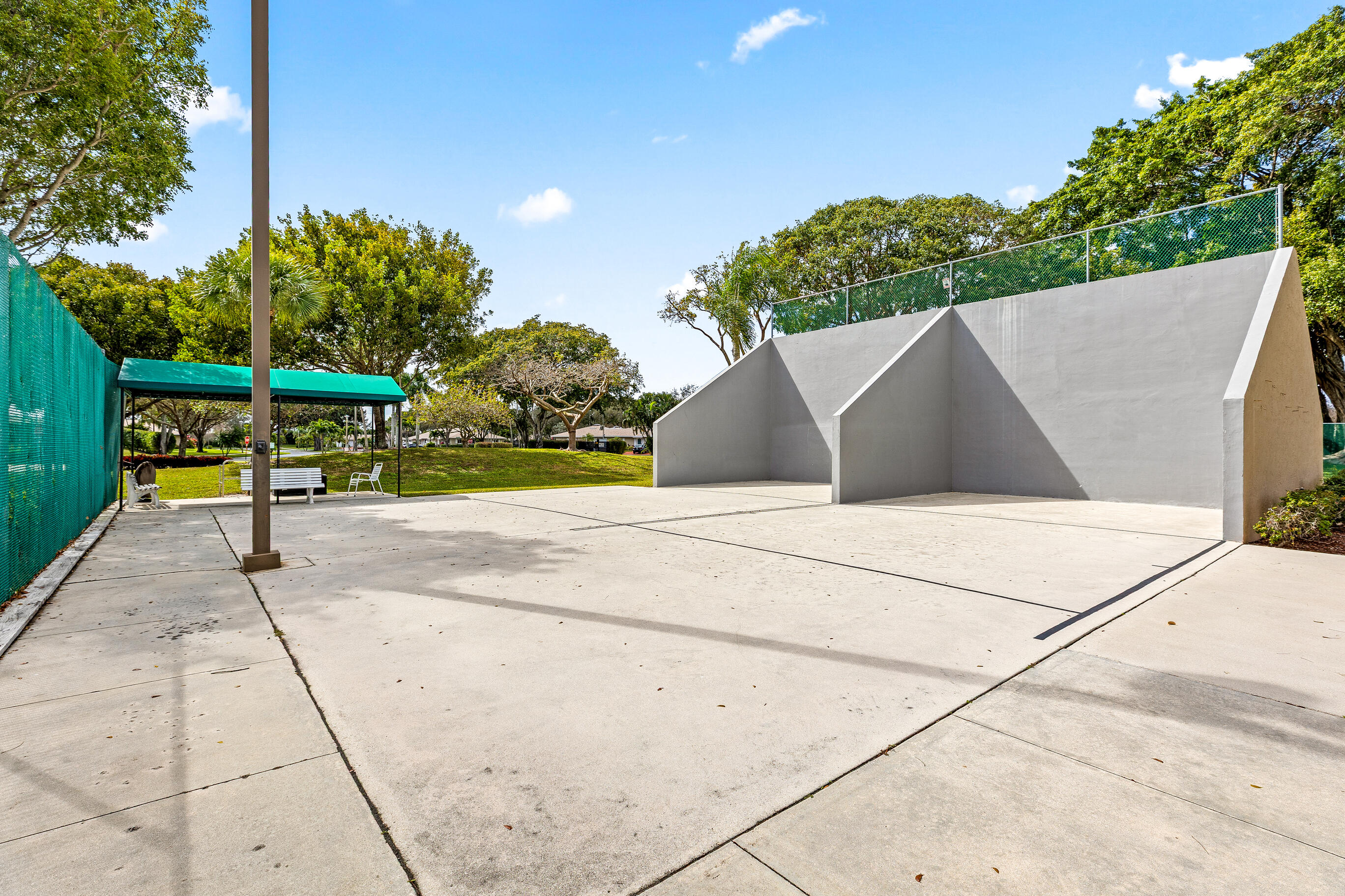 8089 Springtree Road Boca Raton, FL 33496 - Photo 29 of 35 a view of a park with plants and a bench