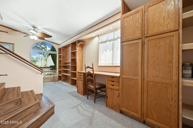 a view of a livingroom with furniture and a window