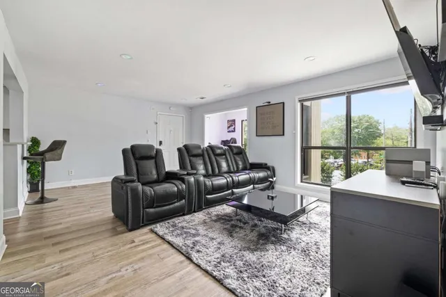 a living room with furniture and large windows