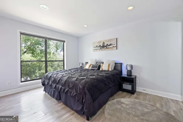 a bed room with a bed and a large window