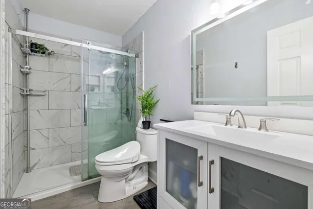 a bathroom with a sink toilet and shower