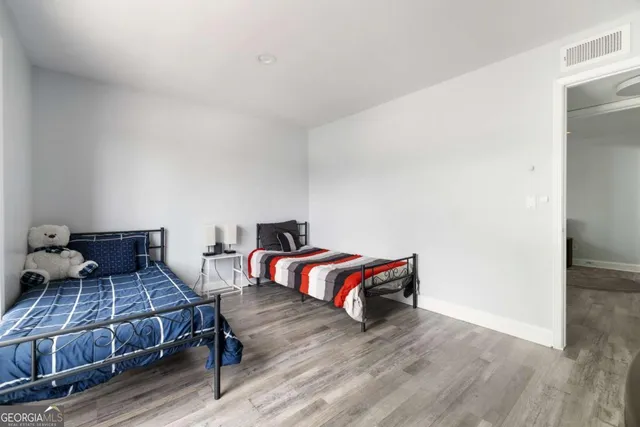 a bedroom with furniture and wooden floor