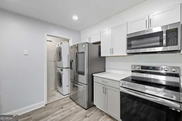 a kitchen with stainless steel appliances a refrigerator stove and microwave