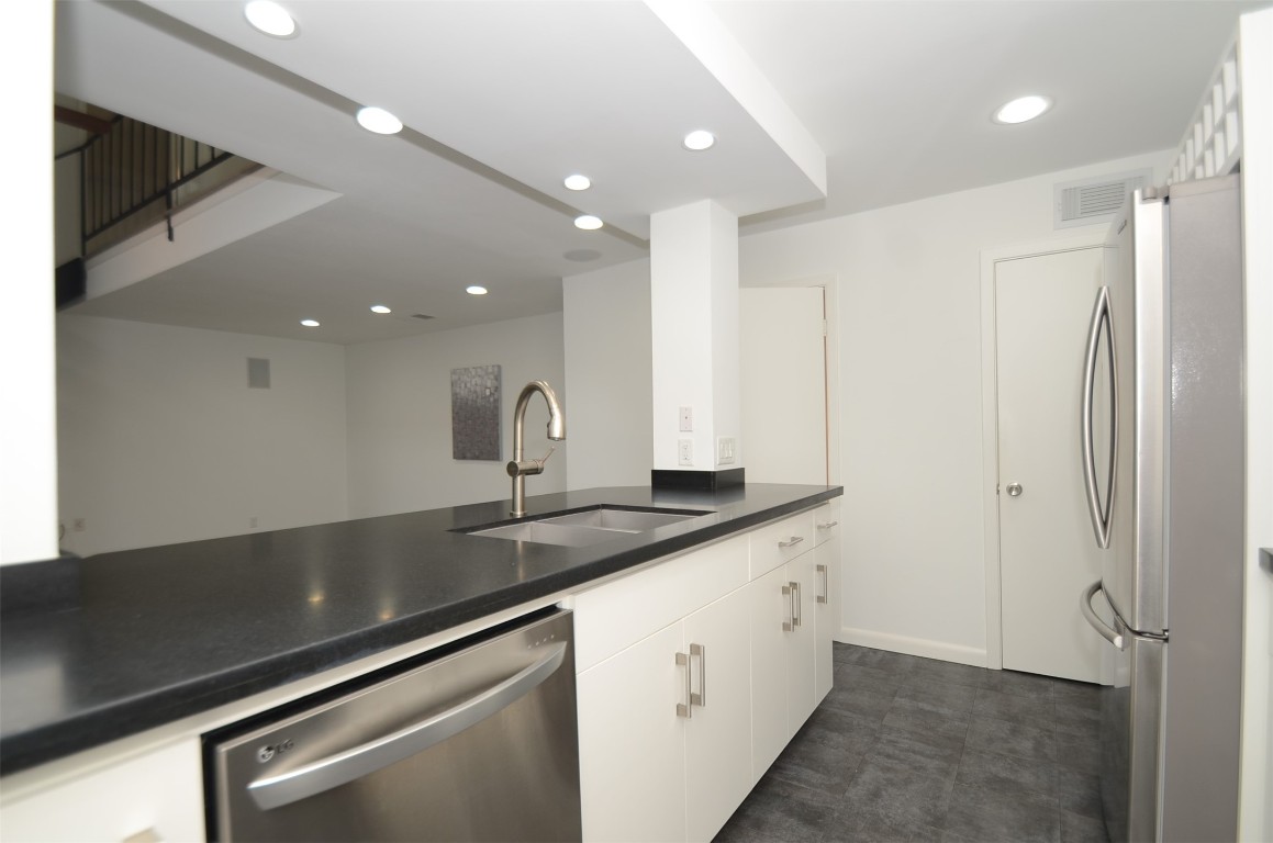 5524 Beverly Hill Street, Unit 2 Houston, TX 77056 - Photo 10 of 43 a kitchen with a sink and refrigerator